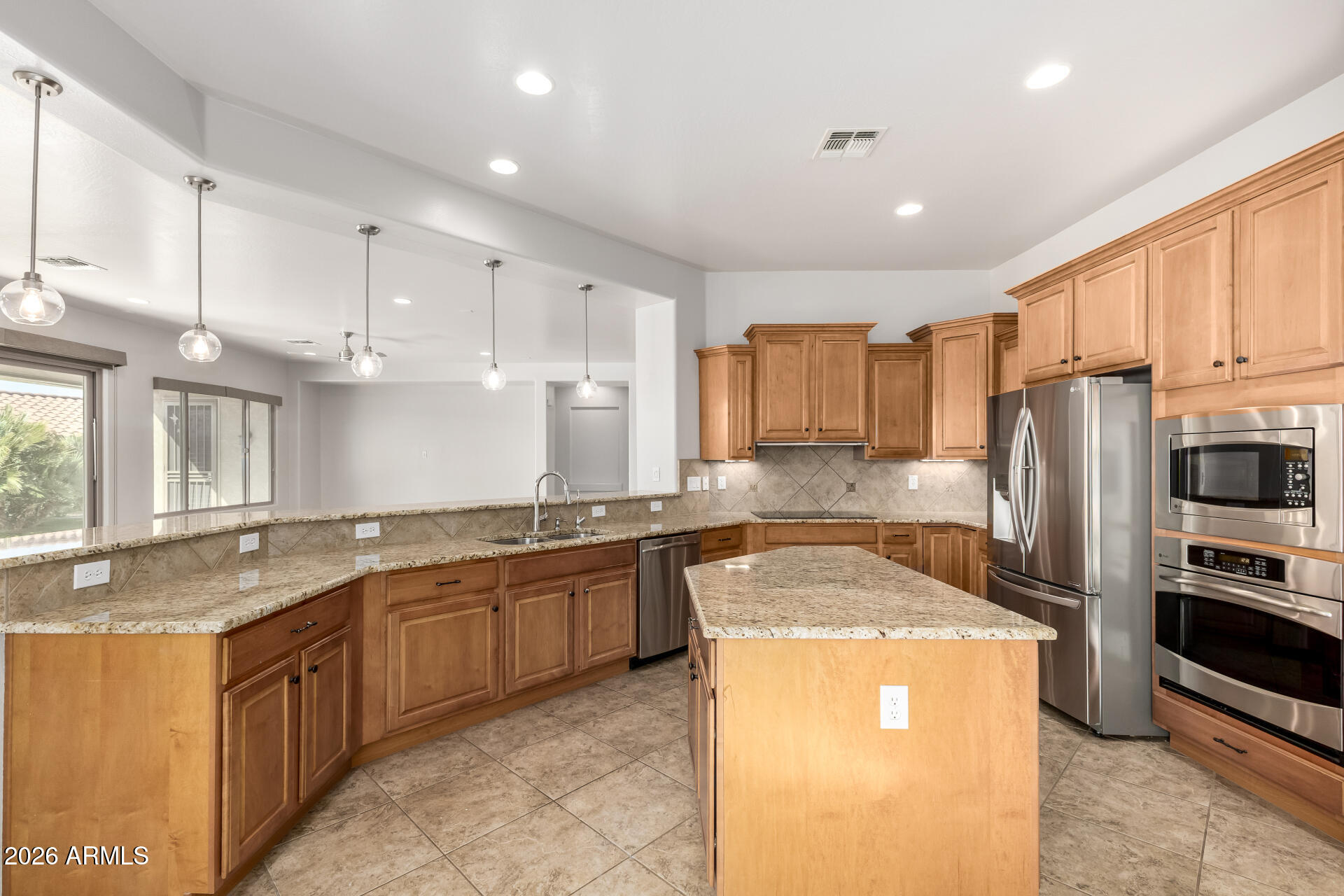 27119 West Burnett Road Buckeye, AZ 85396 - Photo 19 of 56 a kitchen with stainless steel appliances granite countertop a sink stove refrigerator and cabinets