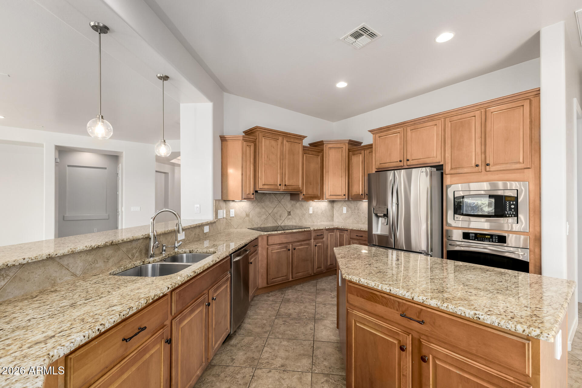 27119 West Burnett Road Buckeye, AZ 85396 - Photo 20 of 56 a kitchen with stainless steel appliances granite countertop a sink refrigerator and microwave