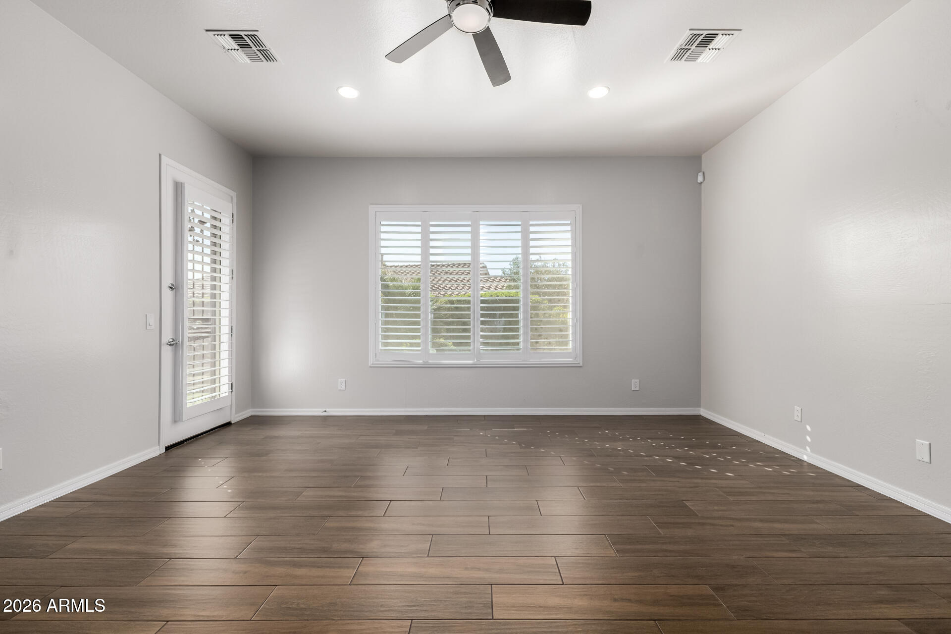 27119 West Burnett Road Buckeye, AZ 85396 - Photo 26 of 56 wooden floor in an empty room with a window
