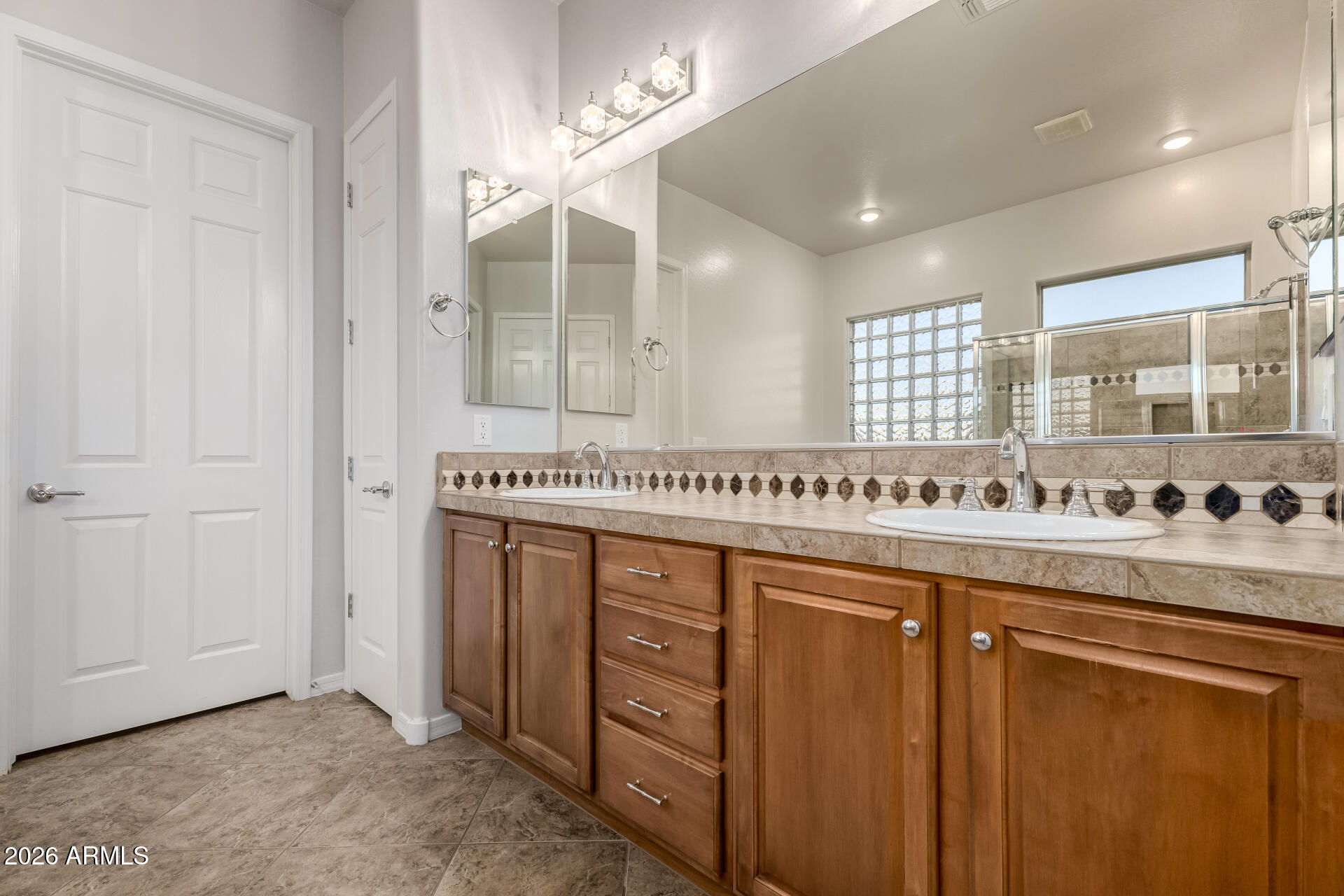 27119 West Burnett Road Buckeye, AZ 85396 - Photo 27 of 56 a kitchen with stainless steel appliances granite countertop a sink and a white cabinets