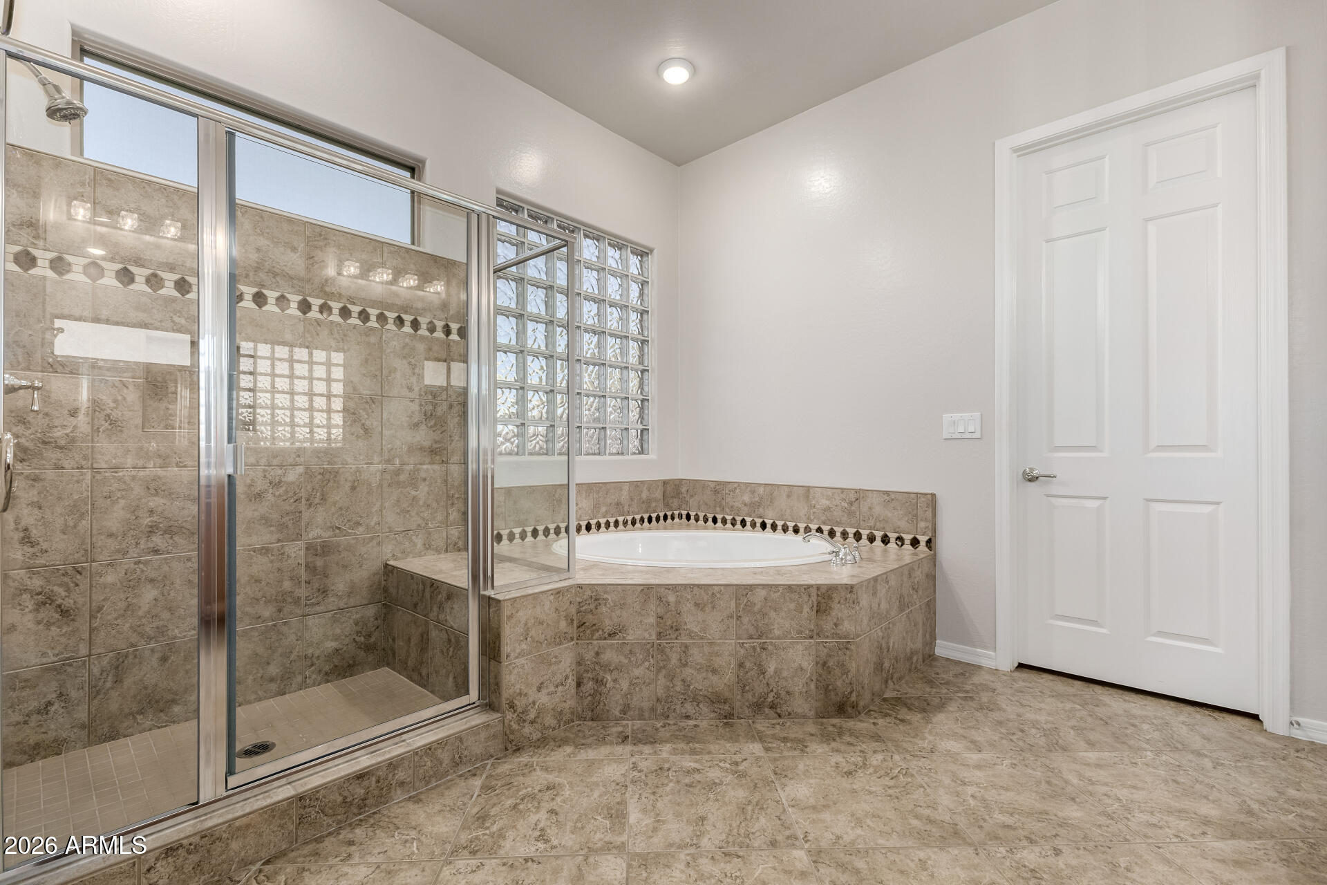 27119 West Burnett Road Buckeye, AZ 85396 - Photo 28 of 56 a bathroom with a bathtub and a shower