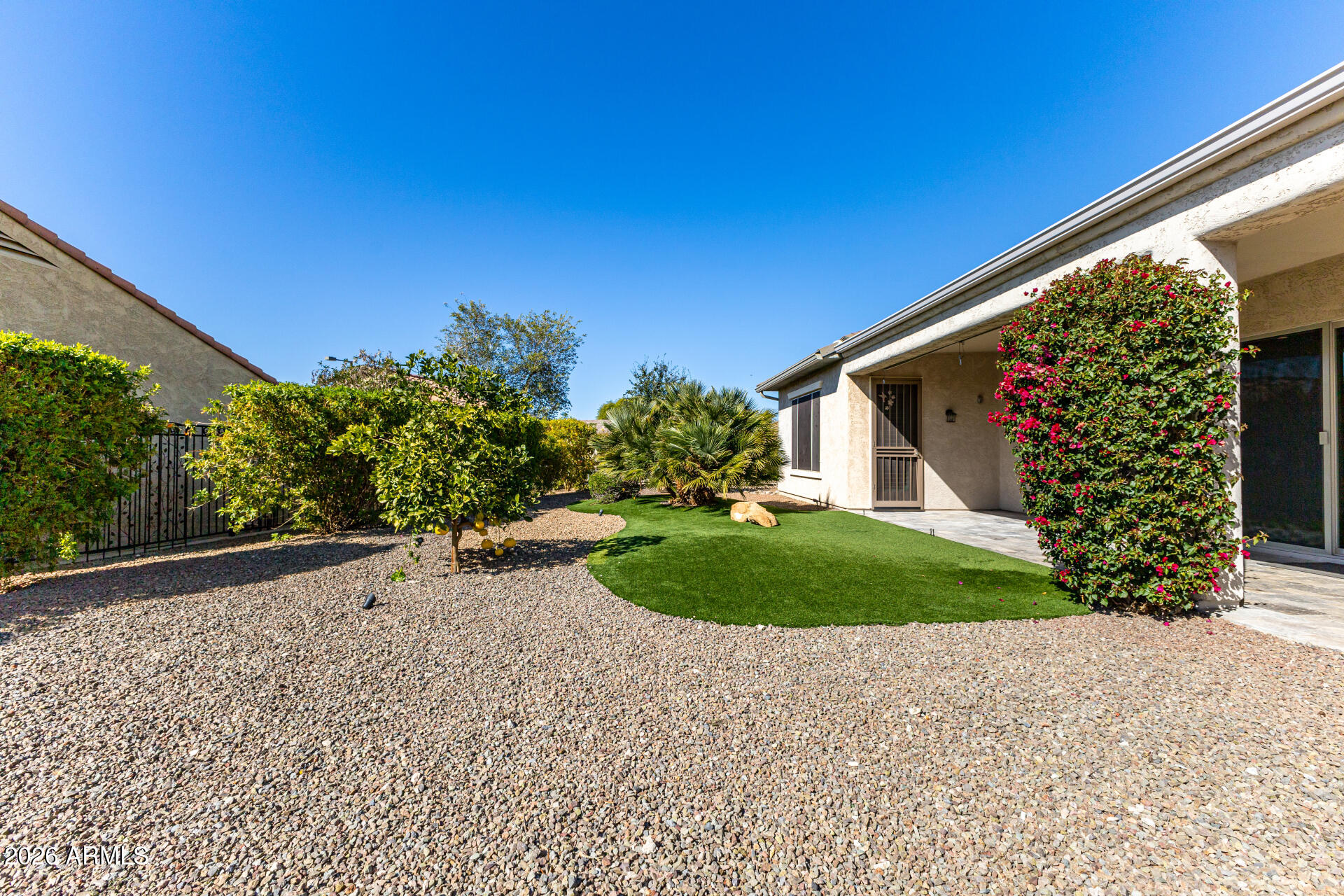 27119 West Burnett Road Buckeye, AZ 85396 - Photo 43 of 56 a front view of a house with a yard and garage
