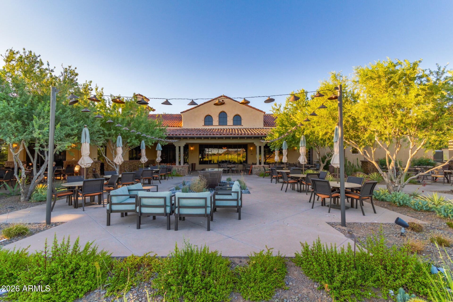 27119 West Burnett Road Buckeye, AZ 85396 - Photo 48 of 56 a view of a patio with table and chairs potted plants and a large tree