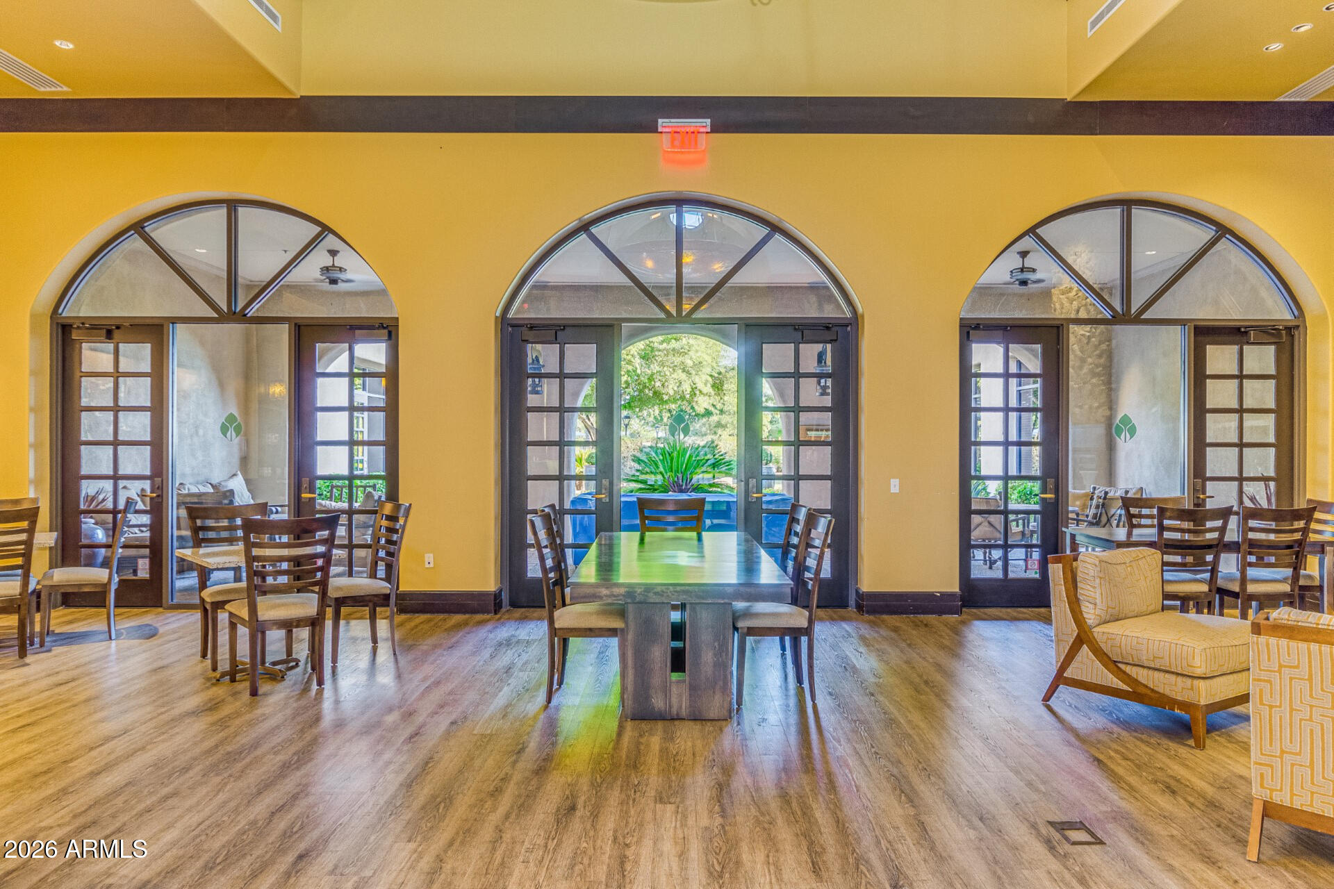 27119 West Burnett Road Buckeye, AZ 85396 - Photo 49 of 56 a living room with couches and dining table with wooden floor