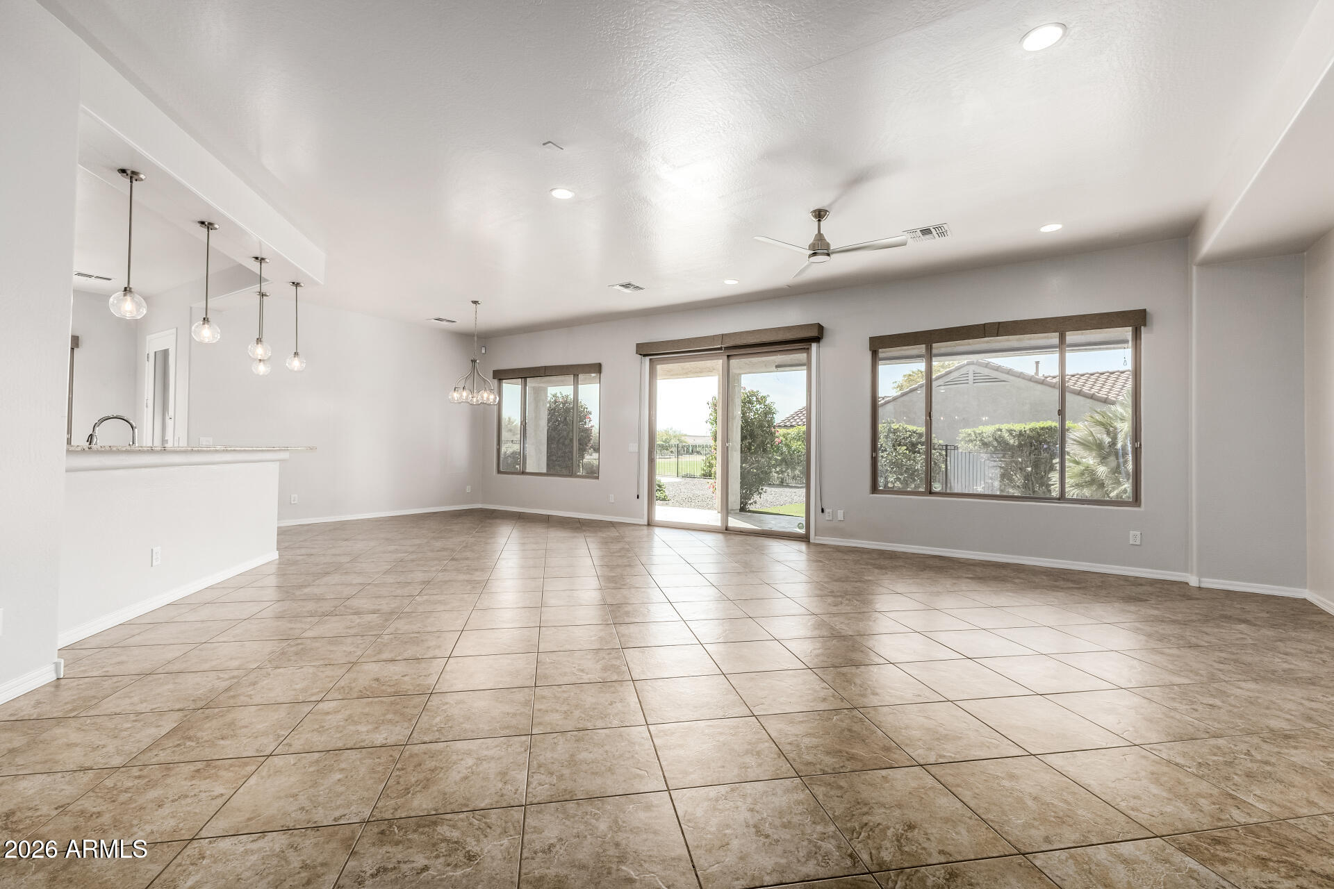 27119 West Burnett Road Buckeye, AZ 85396 - Photo 10 of 56 wooden floor in an empty room with a window