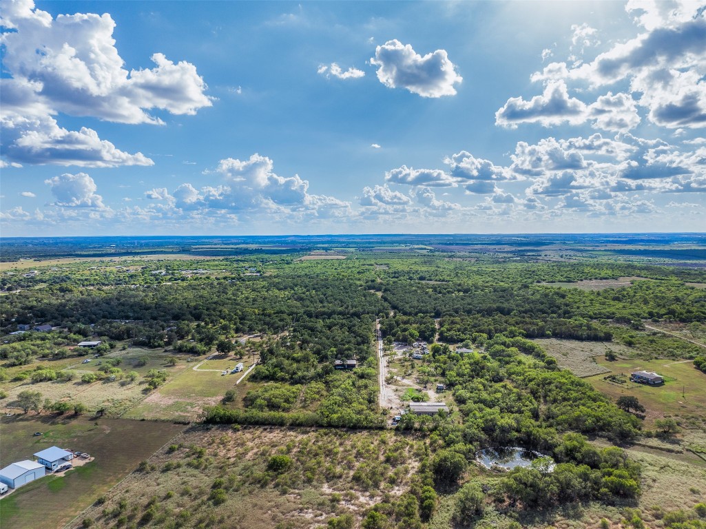 399 Seals Creek Road Lockhart, TX 78644 - Photo 2 of 40 a view of a big yard with lots of green space and mountain view