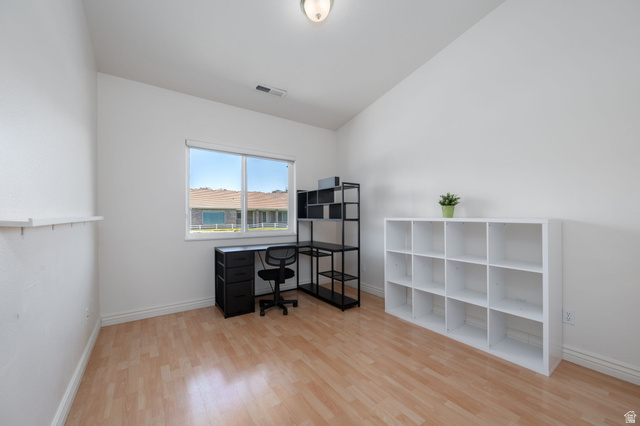 805 South River Road, Unit 70 St. George, UT 84790 - Photo 25 of 38 Bright room featuring wood-finish flooring, white walls, and a large window