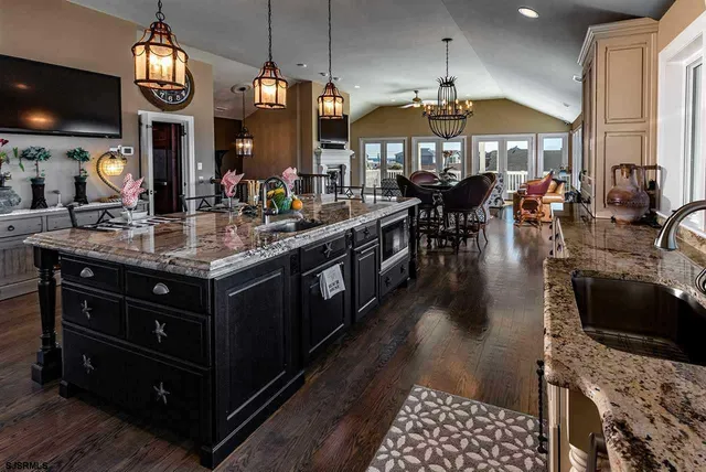 a kitchen with lots of counter space and painting on the wall