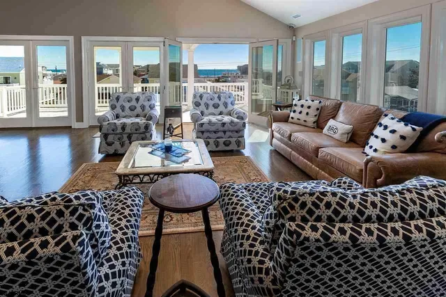 a living room with furniture and a floor to ceiling window