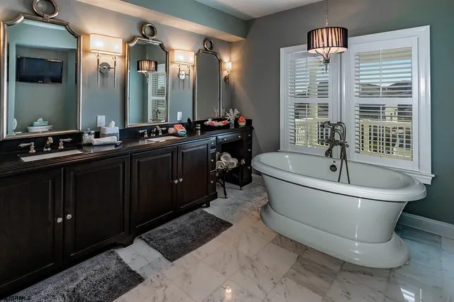 a bathroom with a bathtub sink and mirror