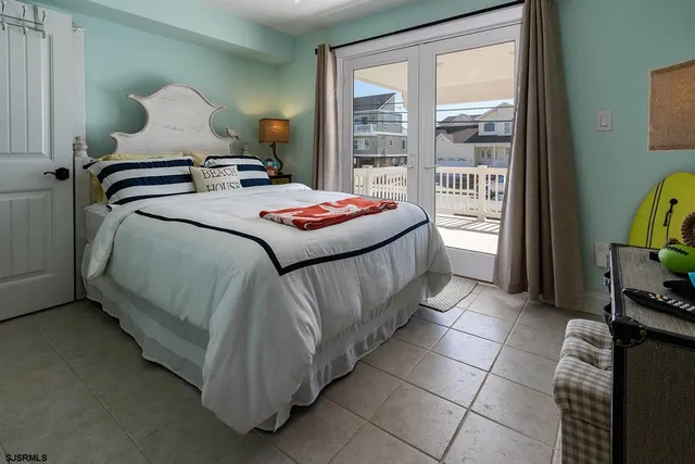 a bedroom with a bed and glass window