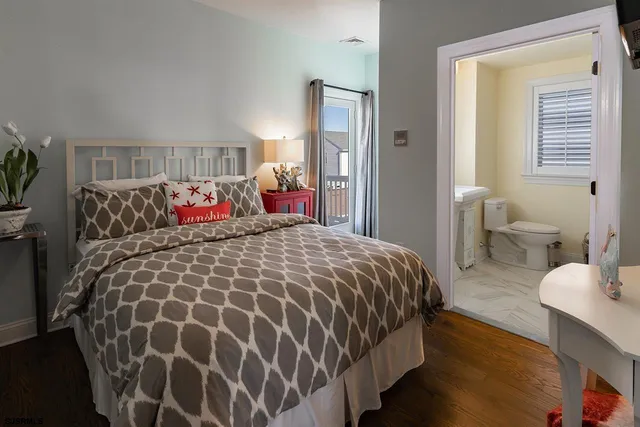 a bed sitting in a bedroom next to a window and a lamp