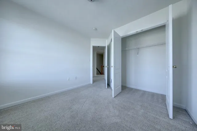 a spacious bathroom with a granite countertop sink a mirror and a