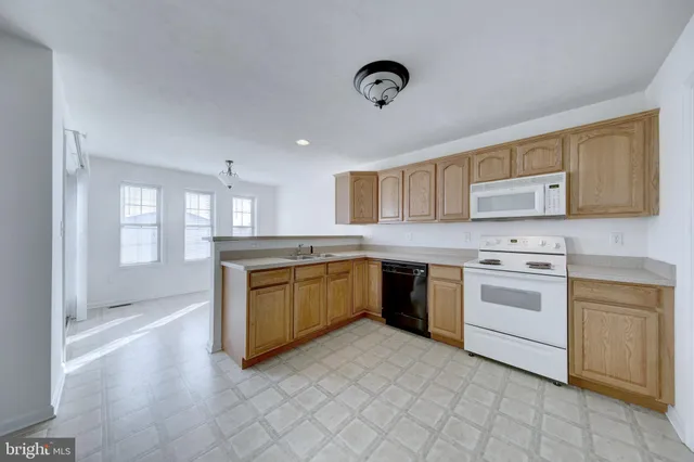 a kitchen with a stove top oven sink and cabinets