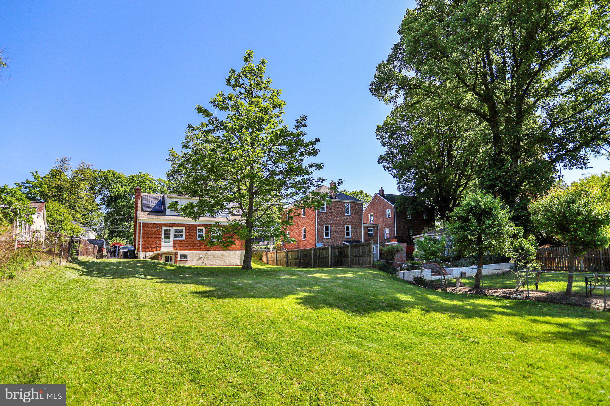 616 Ritchie Avenue Silver Spring, MD 20910 - Photo 33 of 37 a view of a house with a big yard and large trees