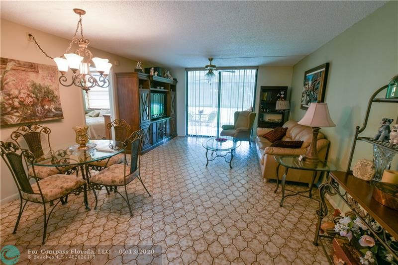 7350 Northwest 18th Street, Unit 101 Margate, FL 33063 - Photo 7 of 28 Very spacious living and dining room with tiled floors.