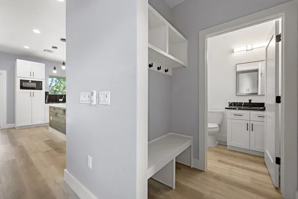 a view of a kitchen with refrigerator and white cabinets