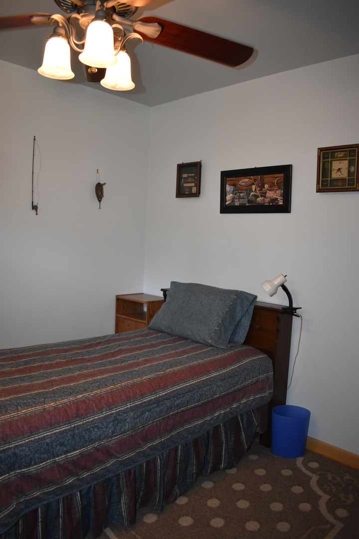 2845 River Road Kankakee, IL 60901 - Photo 19 of 26 a bedroom with a bed and wooden floor
