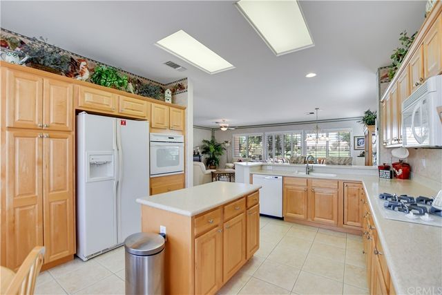 a dining room with furniture a chandelier and window