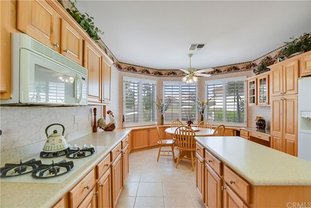 a dining room with furniture a chandelier and window