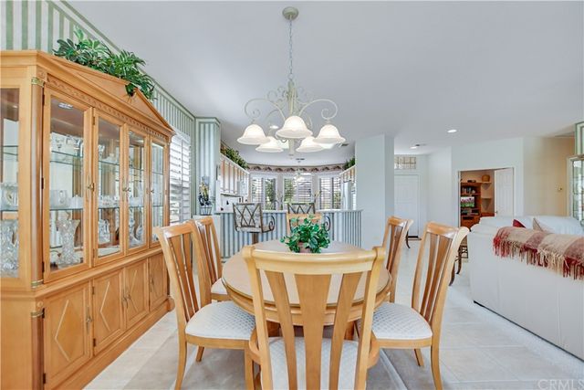 a living room with furniture a chandelier and a large window