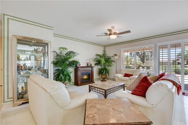 a bedroom with a bed next to a window and a flat tv screen