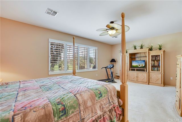 a view of a patio with a table and chairs under an umbrella