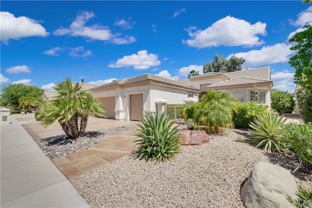 a view of a patio with couches table and chairs and potted plants