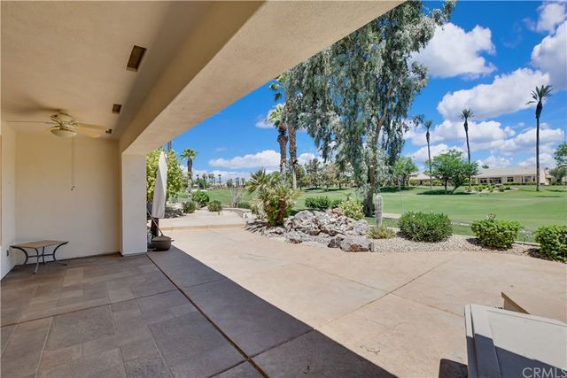 a view of yard with swimming pool and green space