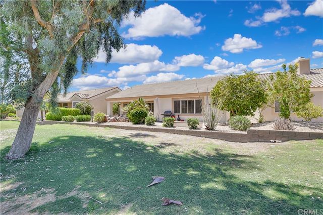 a room with lots of tables a large window and chairs