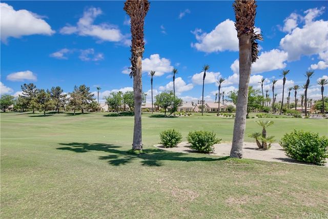 a view of a patio with a table and chairs under an umbrella