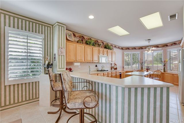 a kitchen with refrigerator and cabinets