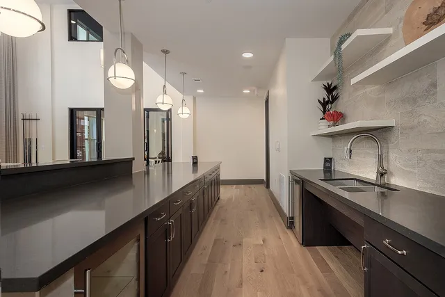 a kitchen with stainless steel appliances a sink a stove and a refrigerator