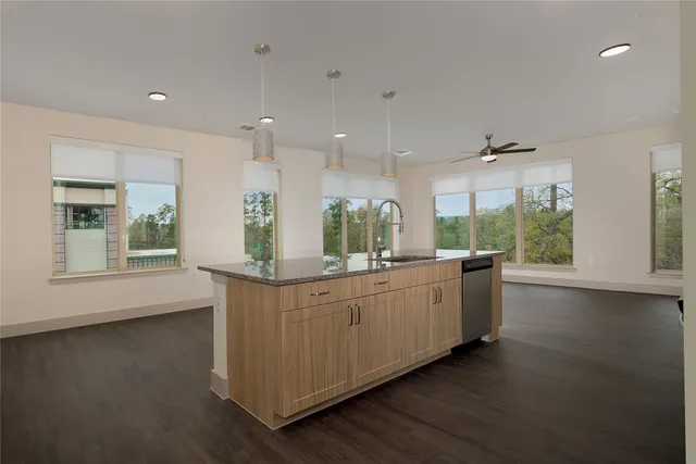 a kitchen with granite countertop a stove and a wooden floors
