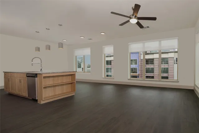 a view of room with hardwood floor and ceiling fan