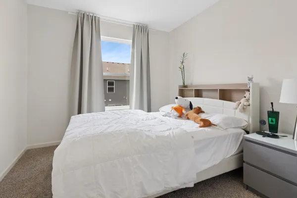a bed room with a bed and a chandelier