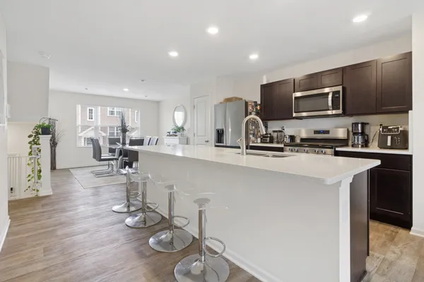 a kitchen with stainless steel appliances kitchen island granite countertop a sink and cabinets
