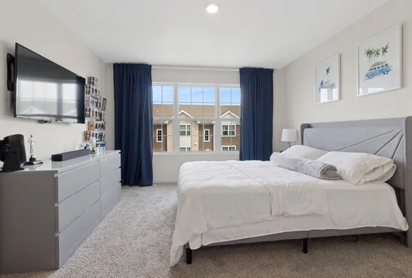 a bedroom with a large bed and a flat screen tv
