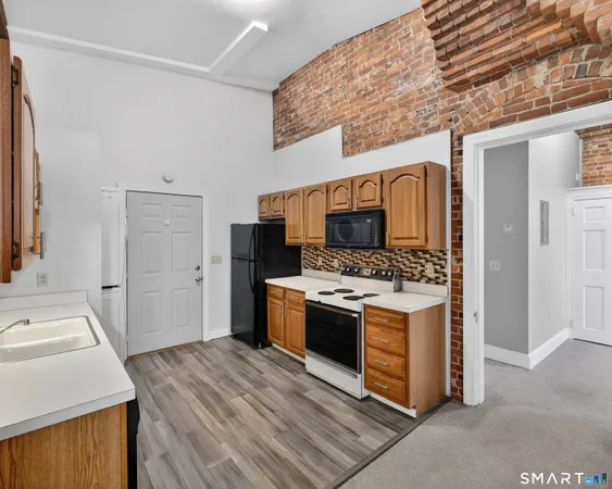 a kitchen with stainless steel appliances granite countertop a stove and a refrigerator