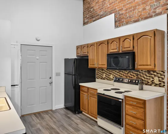 a kitchen with stainless steel appliances a refrigerator and a stove top oven