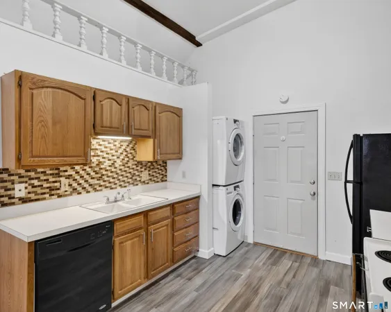 a kitchen with stainless steel appliances granite countertop a sink and wooden cabinets