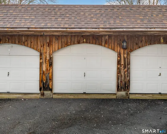 a view of a white building among the street with palm trees