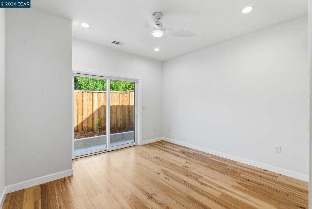 3196 Rohrer Drive Lafayette, CA 94549 - Photo 24 of 30 an empty room with wooden floor and windows