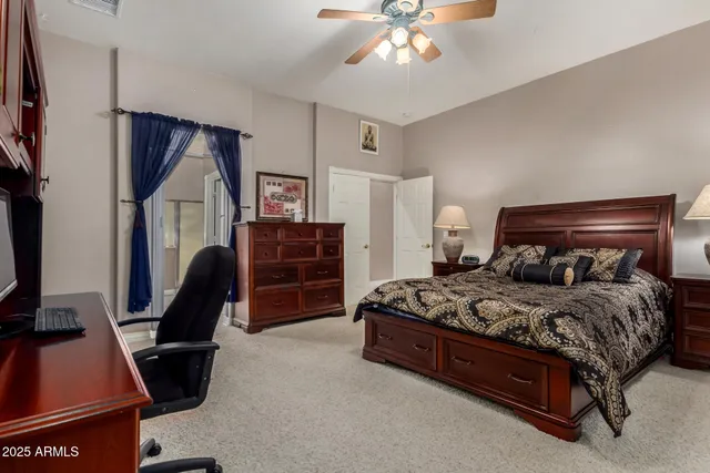 a bedroom with a bed a desk and chair