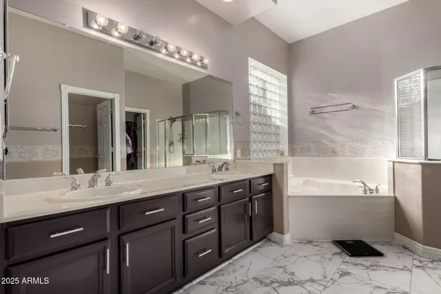 a spacious bathroom with a bathtub sink and mirror
