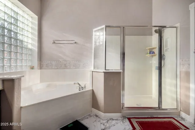 a bathroom with a bathtub and a shower