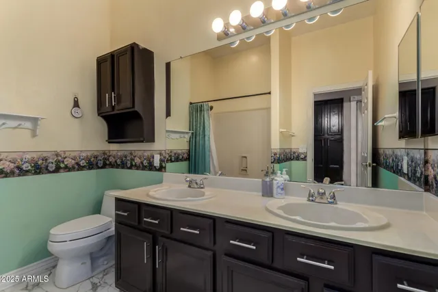 a bathroom with a double vanity sink and a mirror
