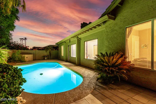 an aerial view of a house with swimming pool patio and outdoor seating