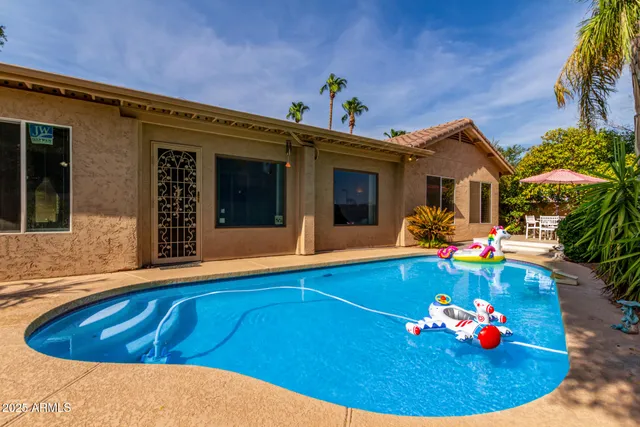 a view of swimming pool with seating space