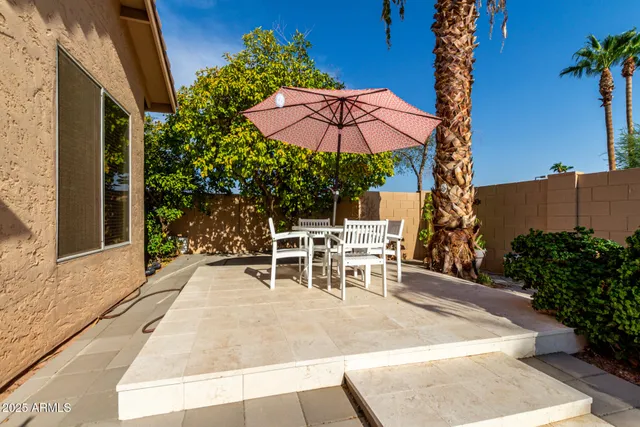 an outdoor space with patio and white umbrellas